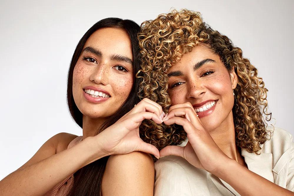 image of two women joining their hands to create a heart