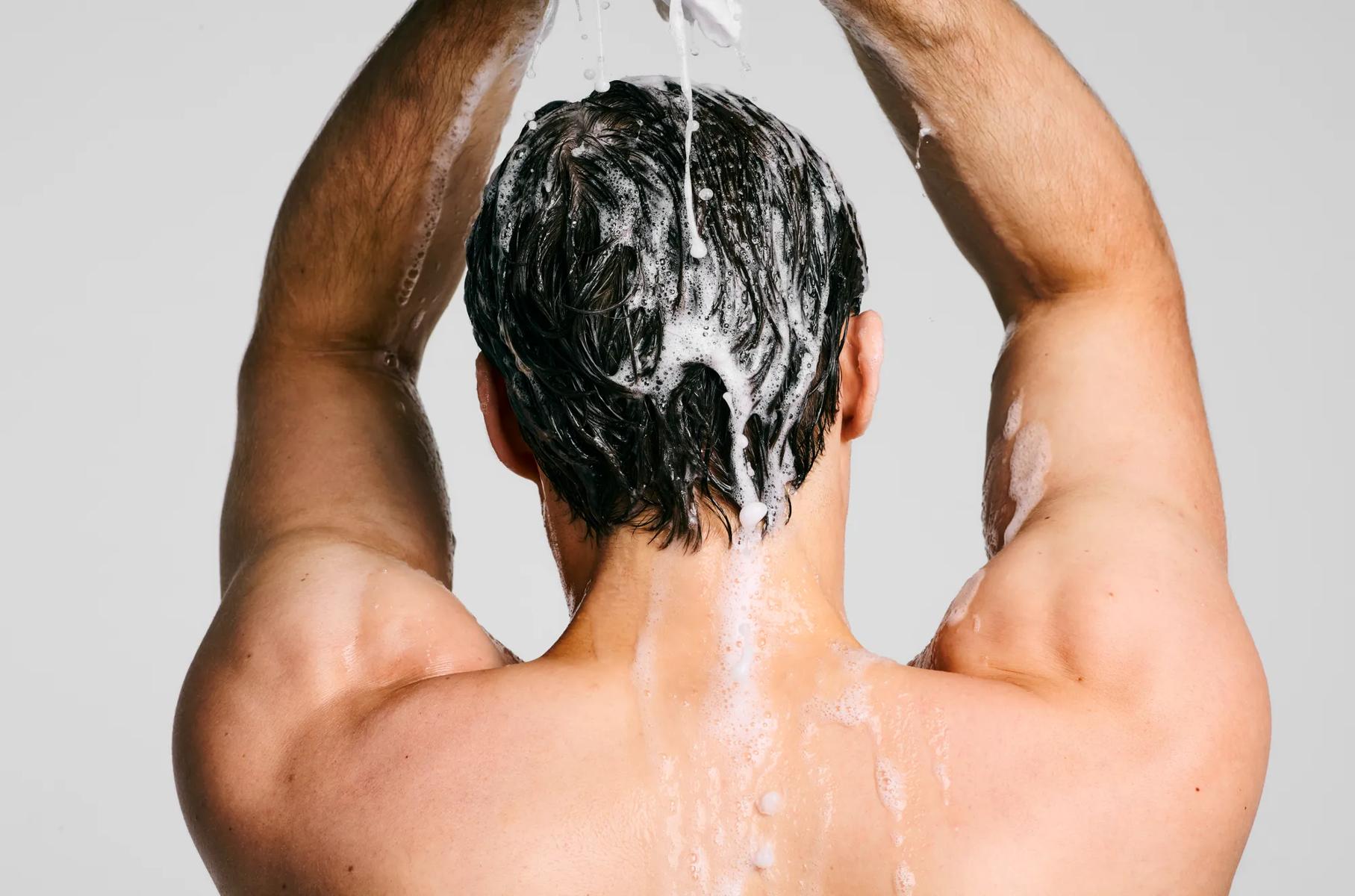 image of a man shampooing his hair