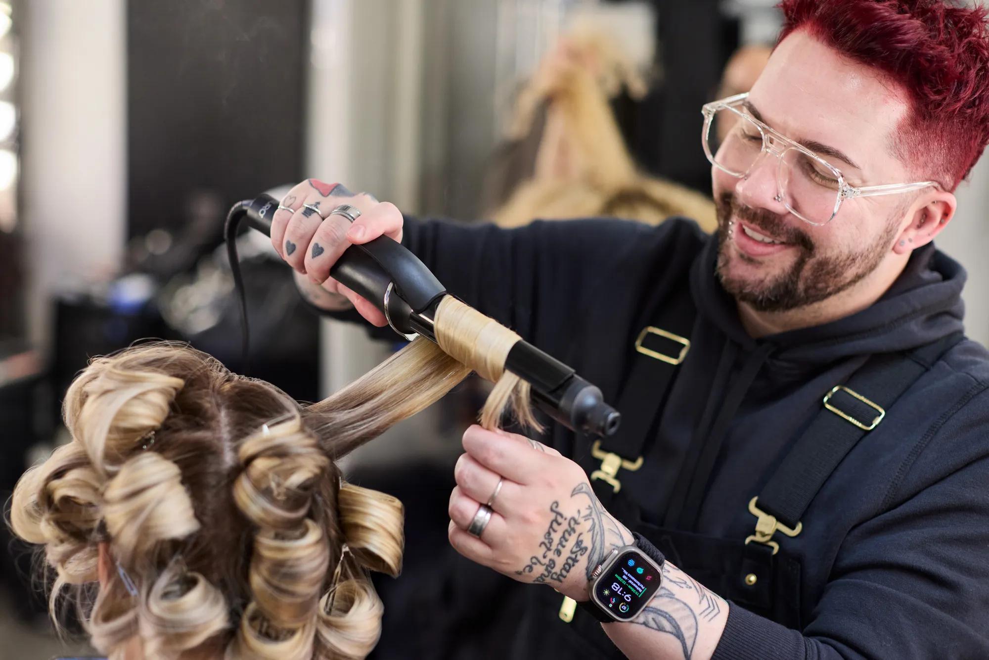 image of Joey Rodrigues styling the hair of a model
