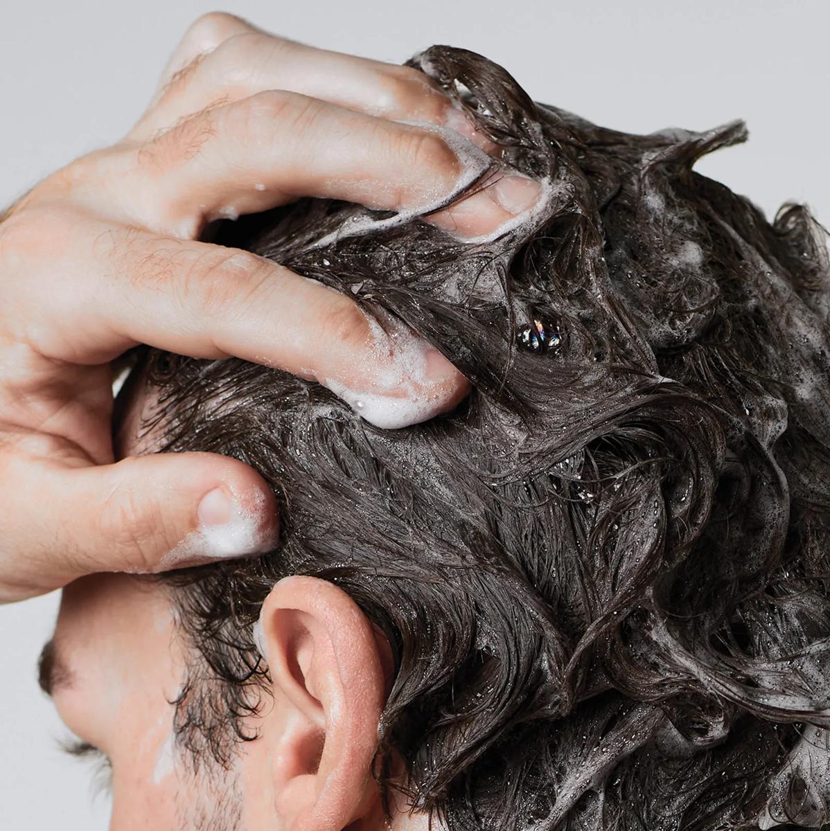 image of a man washing her hair