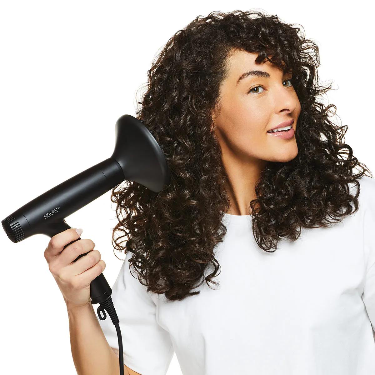 image of a woman blow drying her hair