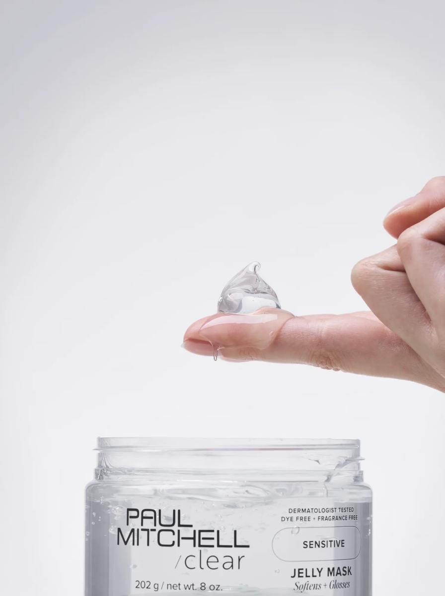close up image of a person holding a dollop of Clear Jelly Mask on their finger