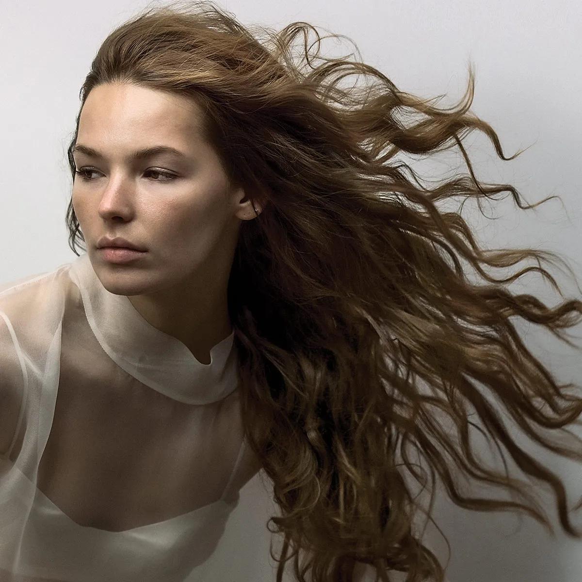 image of a woman with wavy brown hair
