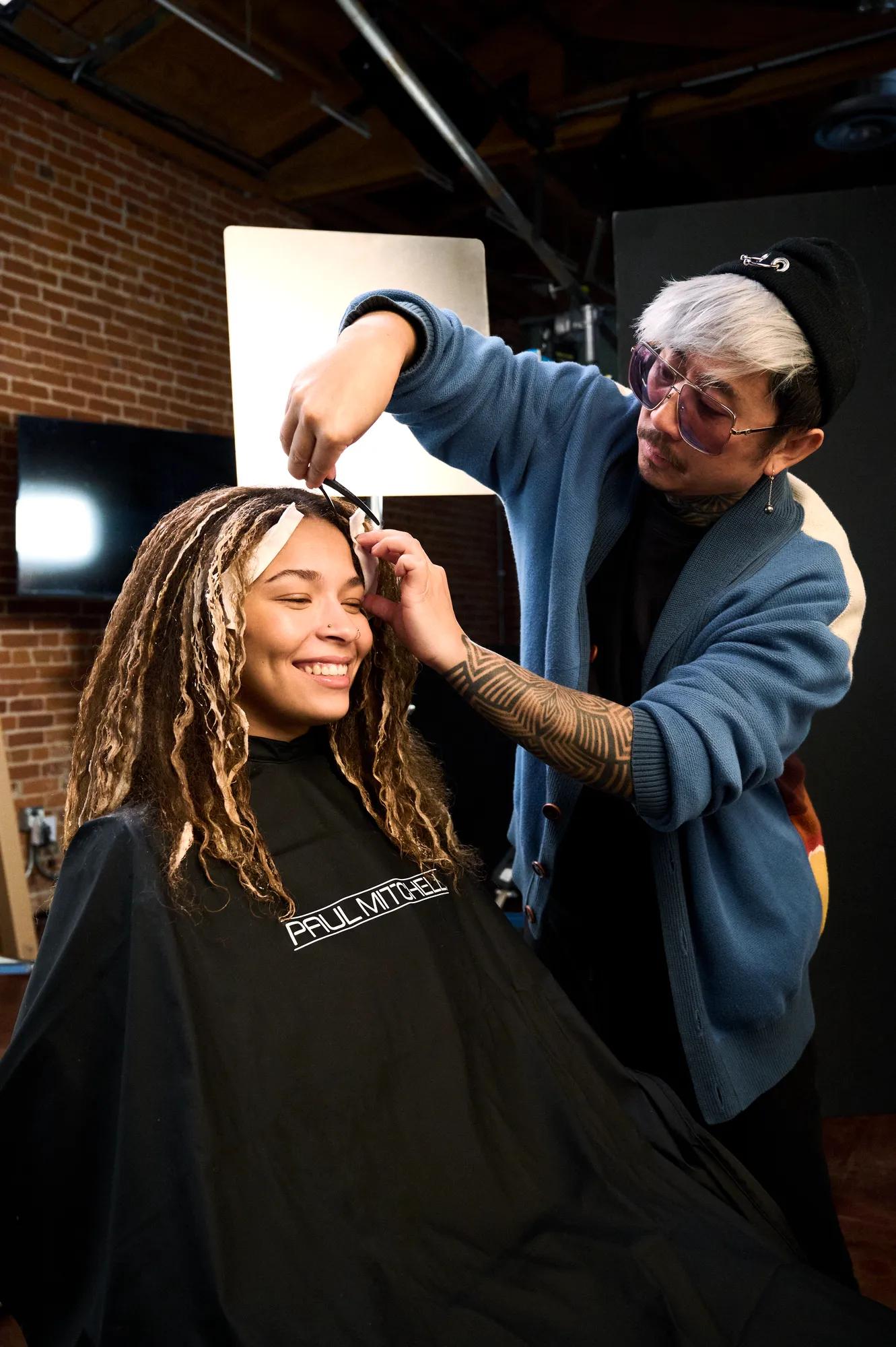 image of Noogie Thai styling the hair of a model