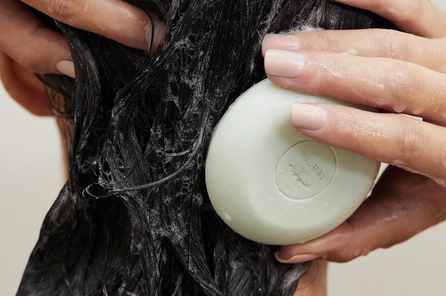 a woman using the Tea Tree Special Shampoo Bar