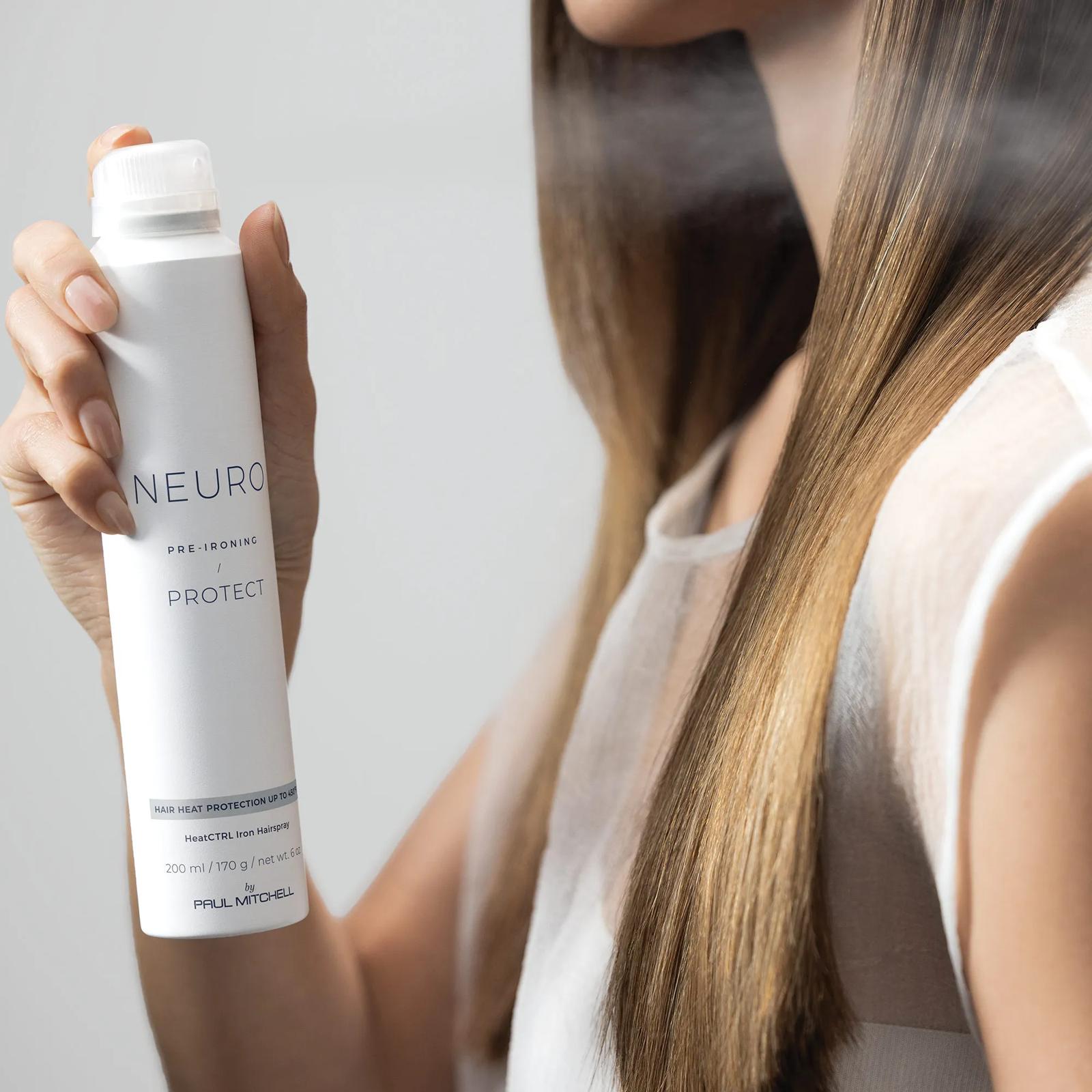 image of a woman spraying Neuro Protect onto her hair
