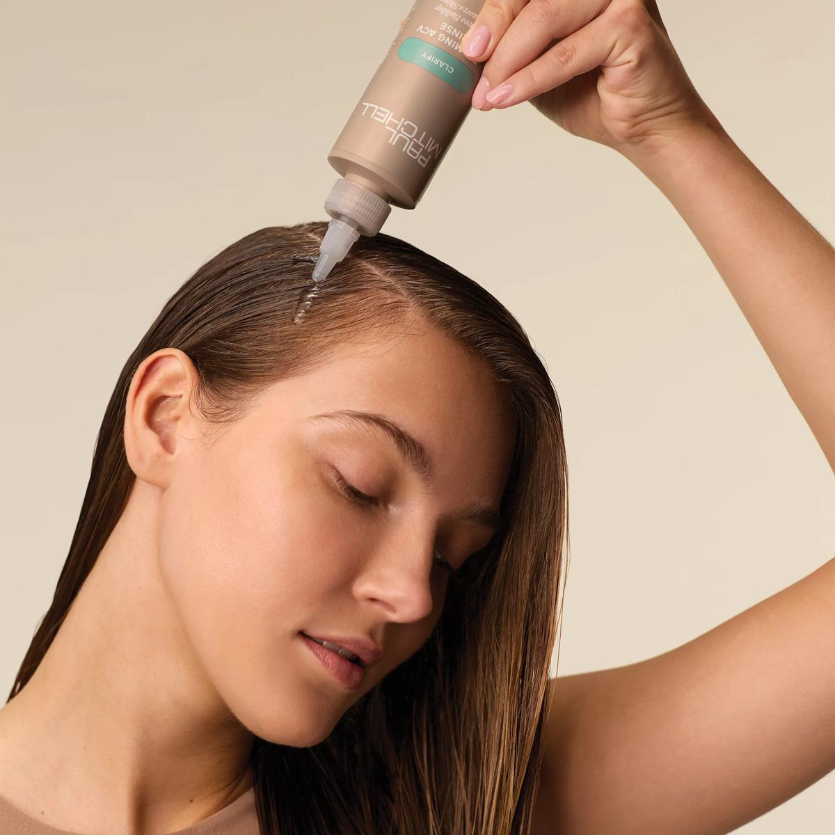 image of a model applying Paul Mitchell Foaming ACV Rinse onto their hair roots